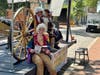 Four visitors in Revolutionary War era clothing posing for pictures