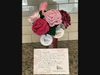Each flower has an attached tag with the name and state of the creator.