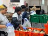 Volunteers pack fresh lettuce and kale at Advocate Trinity’s Food Farmacy before distributing them to patients struggling with food insecurity. 
