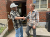 Willie Barry, Food Farmacy patient, shakes hands with Chris Cubberly, Smart Farm manager, after fresh produce from the farm was delivered to the South Side for distribution.