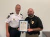 Decatur Police Inv. Robert Lindsey is recently given the Lifesaving Award from Decatur Police Chief Scott Richards for providing aid to a man in a car accident.