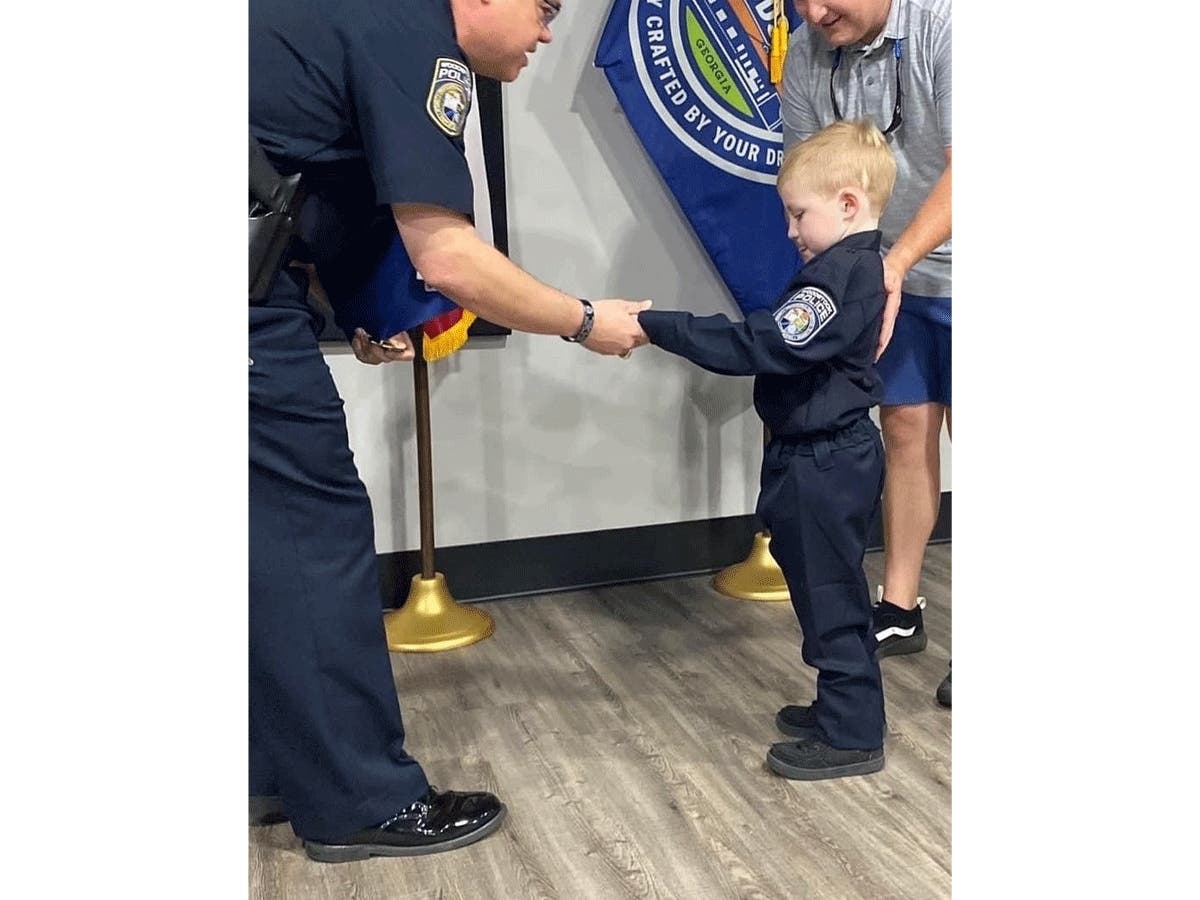 Ezra King, 6, is sworn in as a junior officer for the Woodstock Police Department on Sept. 2. The young boy, who is the son of a Woodstock police officer, is battling cancer.