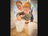 Camden is assisted as he collects coins for the Big Blue Marble Academy - Campground Road's Change for a Change service learning Heart Project, which benefit mothers and babies in Sierra Leone, West Africa.