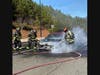 A person escapes a vehicle fire Thursday at Northside Cherokee Boulevard.