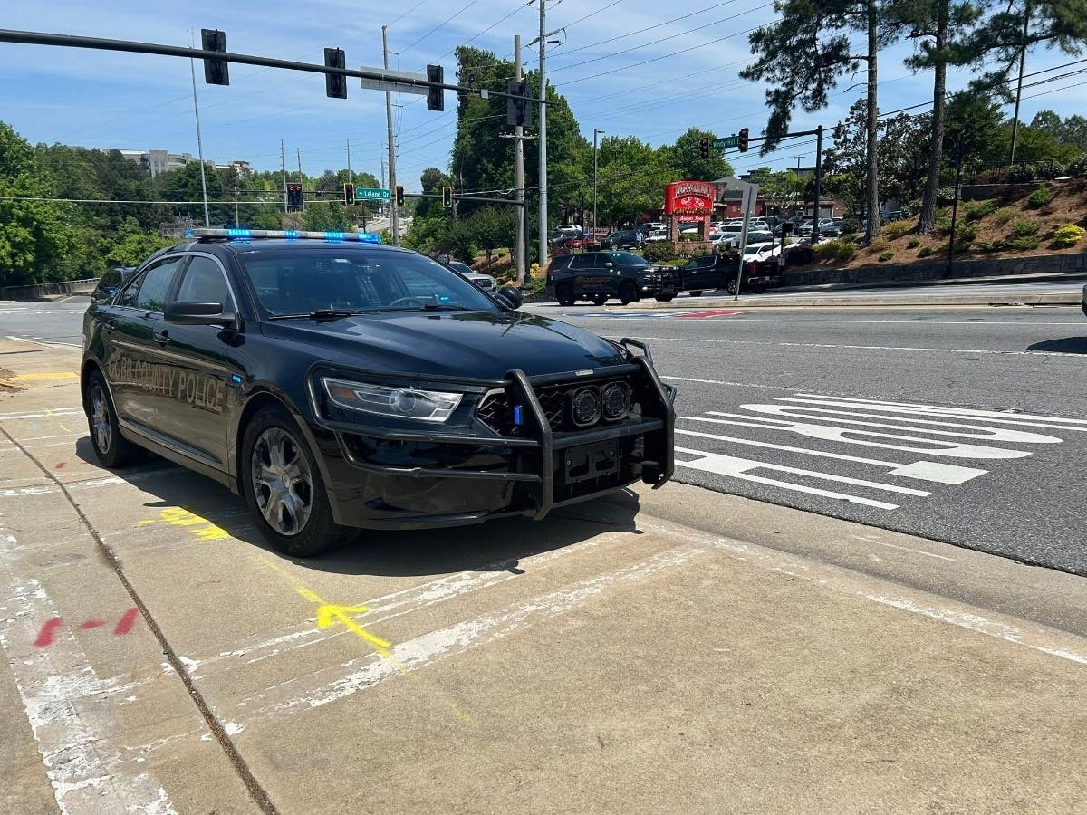 Cobb County Police are searching for a suspect accused of pointing a gun at an officer around 1 p.m. Tuesday in the area of Leland Drive and Windy Hill Road.