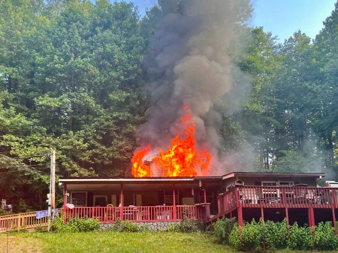 A fire erupts around 6:30 p.m. Wednesday at a Ball Ground home in Cherokee County.