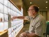 UConn Chemistry Department faculty member Christian Brückner places items representing elements in the interactive Periodic Table Display as it was being installed in the Chemistry Building on Aug. 26, 2022.
