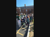 Bedford Road School students give high-fives to the football players.
