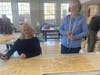 On "Sewing Saturday" community volunteers come to help design, cut, sew and iron costumes for the high school play