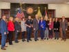 The Board, Commissioner, and those recognized for their contributions to the community 