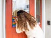 Cape Assist’s Chelysmaly Cruz placing the Safe Space stickers on Cape Assist’s entryway door.  
