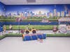 A glimpse of the playful space, featuring a wall mural with an inventions theme in NeurAbilities’ brand-new ABA treatment clinic, located in Harrisburg, Pennsylvania. 