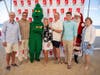 Holiday Express celebrates 2024 honorees: Neil McDevitt (far left), Carol Stillwell (center) & Billy Nagy (third from right), shown with (L to R) emcee Tom Hayes, the Grinch (Natalie Ellis), founder Tim McLoone, Santa (Bob Sterling) & ED Eileen Higgins.

