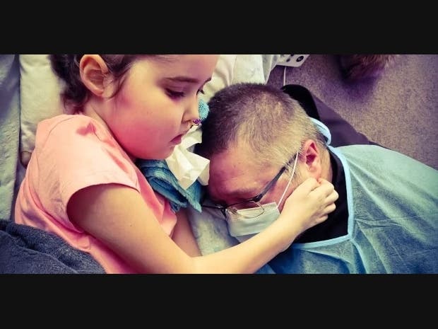 A sick young Ukrainian child comforts her father in a Polish refugee center.  This is an all too frequent occurrence as the adults realize the magnitude of the loss of their home and friends which, fortunately, the children have yet to fully appreciate.