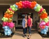 Alice, a current Juniper Village at Lebanon resident, and Evette, Connections Team Member at Juniper Village at Lebanon pose underneath the festive balloon archway.
