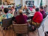 A group of residents engage in conversation in the community living space.