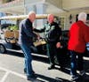 Residents interact with law enforcement during the outdoor National Law Enforcement Day BBQ event.