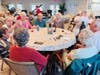 Residents gather around the table for lively conservation and spirited camaraderie.