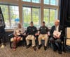 Rosely Robinson, Bill Conley, Colonel Scott Christensen, and fellow community member united during the POW/MIA chair dedication ceremony at The Vero at Newark.