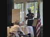 Bobby Baldwin, retired U.S. Marine and Vietnam veteran, leads the Missing Man Table Presentation in honor of fallen and missing service members.