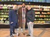 Owners Abee and Moe Aduzahreich pose with Bronx Community Board 4 District Manager Leonardo Coello during the celebration.
