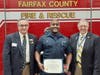 Firefighter Jovan Reid receives the Fire Safety Commendation Medal from the Fairfax Resolves Chapter at Fire Station 9 December 13. Pictured with Reid are Chapter Vice President Jon Rymer (left) and Chapter Past President David Cook (right). 