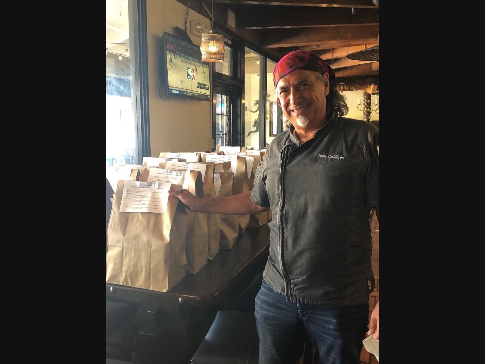 Ivan Rogelio Calderon, Founder and CEO of Taco Rosa in Newport Beach, checks the day's meals.
