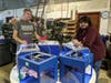 HCC Advanced Manufacturing instructor George Scobie (left) stands with Tristan Hunte and five 3-D printers borrowed from Housatonic Community College to make face shield frames.