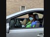 Stamford Senior Center members Michelle DeCarlo and Lou Carrier wave to friends.