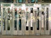 “Telephone Booths,” a composition by Estes of several photographs he took of a row of telephone booths located at the intersection of Broadway, Sixth Avenue and 34th Street in New York City.