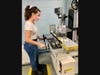 AMTC graduate Sarah Galaburri of Milford demonstrates working with a surface grinder.