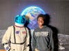 Justin Prior, Lab Coordinator for HCC’s Science Department, appears as an astronaut for a photo booth moment with HCC student, Lubwick Francois.