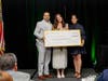 Juan Carlos Arias (left) and Zaida Alvarez (right) present The ECHO Scholarship to Emma Solsana