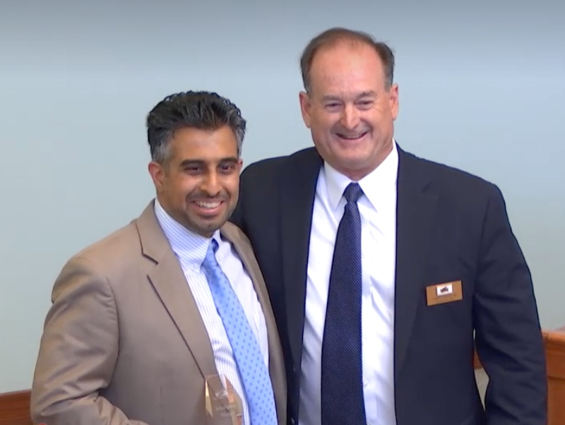 Murtaza Mogri and Mayor Chris Anstead pose for a photo at the Agoura Hills City Council Meeting Wednesday.