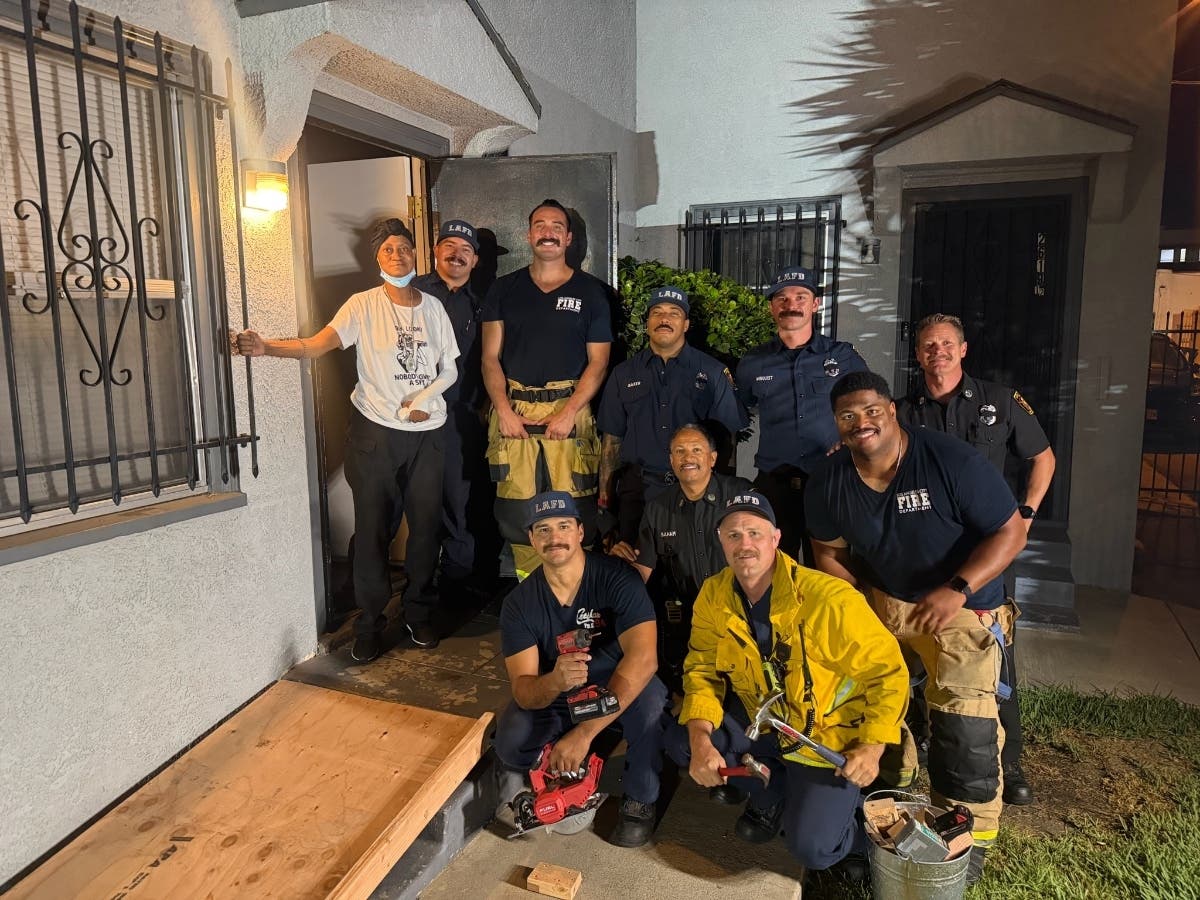 Los Angeles Fire Department firefighters pose with a newly installed wheelchair ramp they built after responding to a public assist call in early September.