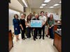 Assemblymember Charles Lavine presents check to Hofstra University President Susan Poser along with biology department faculty and students, September 10, 2026