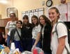 National Art Honor Society members gather to hang murals at men's recuperative care center