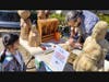 Kiara, age 5, admiring wood carving at NJ Makers Day 2023