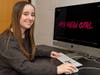 Madeline Hettrick sits by a monitor displaying the title of her short film at the Rutgers Filmmaking Center.