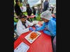 Gaurav Gupta (left), a professor in the Department of Neurosurgery at Robert Wood Johnson Medical School, leads Morgan Nathan through a demonstration of Jell-O "brain surgery" on Busch campus in 2024.