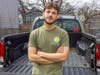 Josh Kover, a senior majoring in landscape architecture, stands behind his truck in New Brunswick, N.J.