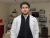 Omar M. Abuattieh stands in a lab room in the Ernest Mario School of Pharmacy.
