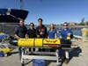 Professor Joe Gradone and student Mason Diaz joined Teledyne employees for the launch of the Redwing glider in Woods Hole, Mass., on Oct. 10. From left: Shea Quinn, Gradone, Diaz, Cordielyn Goodrich and Sal Fricano.