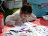 Luciana Medina colors a Rutgers “R” at the R Garden on Voorhees Mall during Rutgers Day 2024.