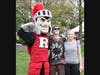 Rutgers mascot Sir Henry (left) poses with young people during Rutgers Day 2024 on the College Avenue campus.