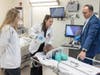 In a simulation lab in the Ernest Mario School of Pharmacy at Rutgers-New Brunswick, Alex Bell (left) watches Amanda Sallemi provide air to a manikin under the guidance of Les Barta.