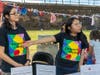 Zimmerli Mobile representatives Hanna Cherres (left) and Jessie Garcia interact with attendees during the Wash and Learn end-of-year celebration on June 9 outside the New Brunswick Public Schools office.