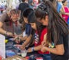 A woman and children participate in an art activity hosted by Zimmerli Mobile during the Wash and Learn end-of-year celebration in New Brunswick, N.J.