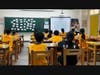 Pauline Kung (back right) teaches English to a class of sixth graders in Taipei.
