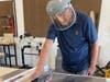 Jubilation member Dick Durst works on building the art gallery/wall in the workshop at the active adult community in Fredericksburg. 